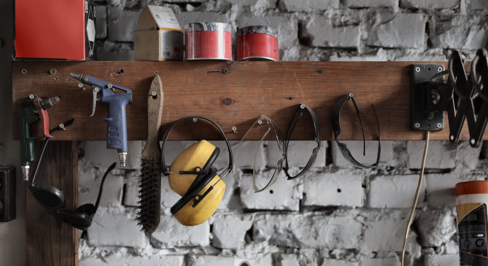 various instruments hanging on wooden board in garage