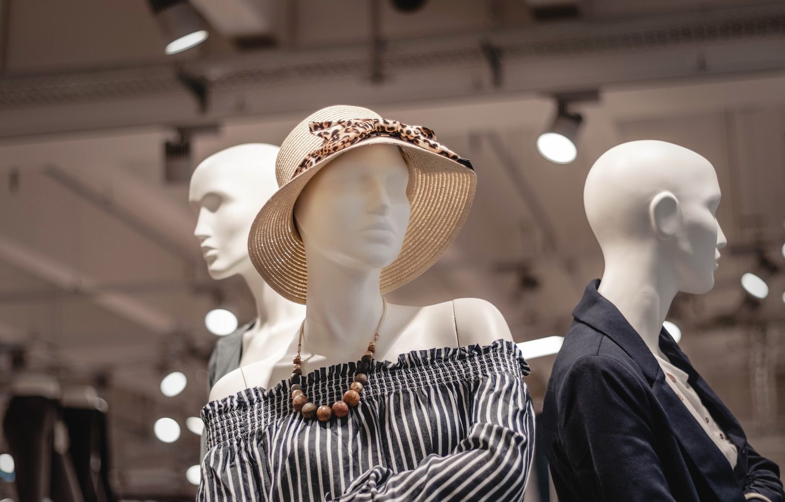 shallow focus photo of mannequin wearing brown sunhat