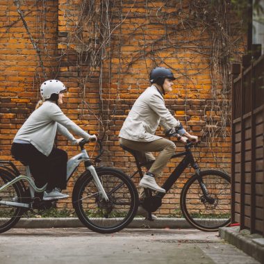 Couple Riding E-Bikes in a City