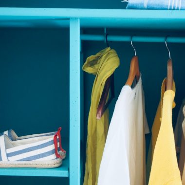 blue shelf with pair of slip-ons and five clothes