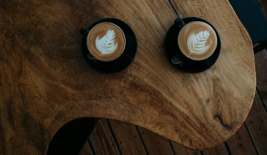 two coffee arts on brown wooden table