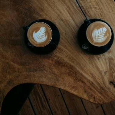 two coffee arts on brown wooden table