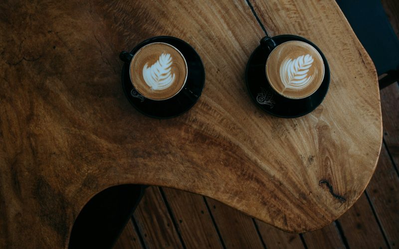 two coffee arts on brown wooden table