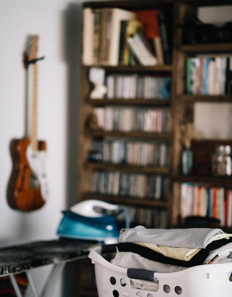 brown acoustic guitar on brown wooden shelf