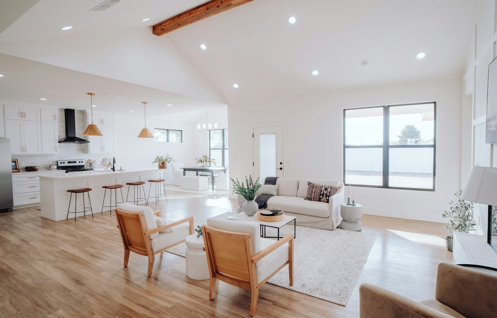 a living room filled with furniture and a kitchen