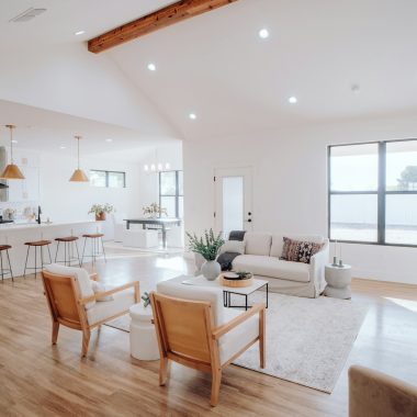 a living room filled with furniture and a kitchen