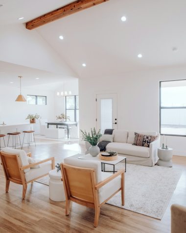 a living room filled with furniture and a kitchen