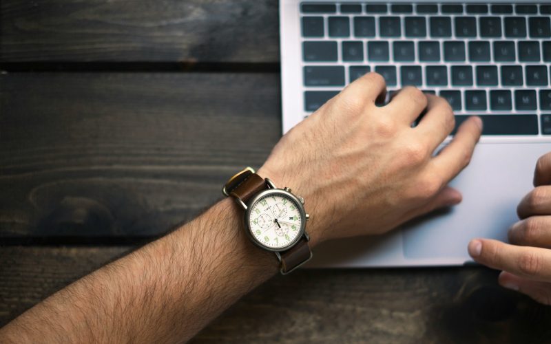 person wearing brown and white watch