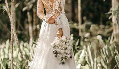 woman holding white flower bouquet during daytime