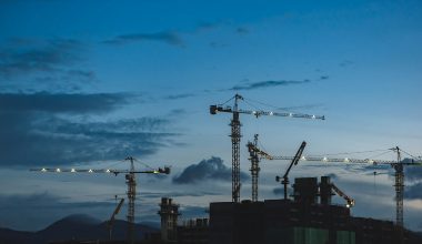 several cranes above the buildings