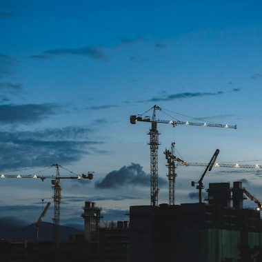 several cranes above the buildings