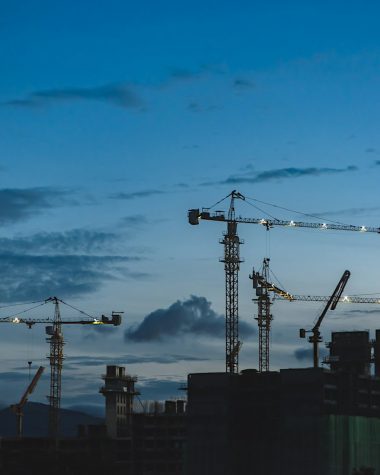 several cranes above the buildings