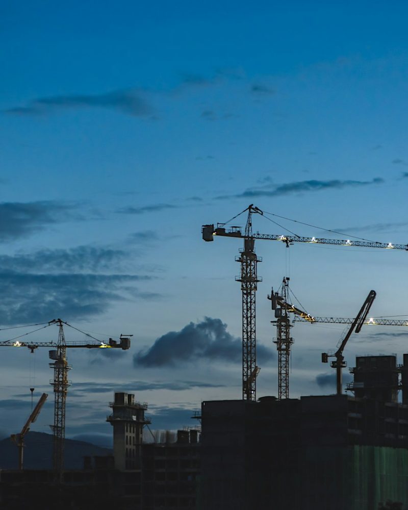 several cranes above the buildings