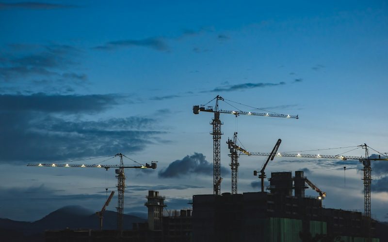 several cranes above the buildings