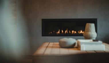 a table with a vase and a fire place on it