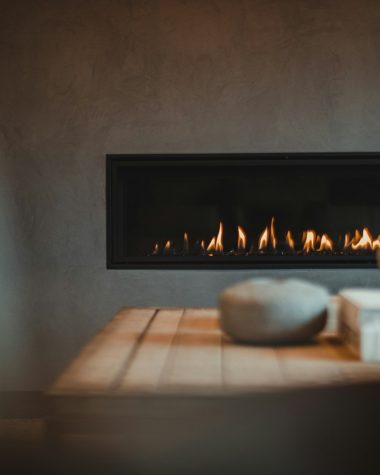 a table with a vase and a fire place on it