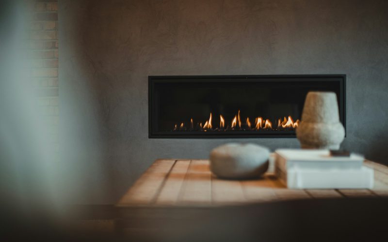 a table with a vase and a fire place on it