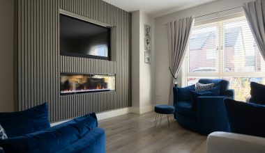 a living room filled with furniture and a flat screen tv