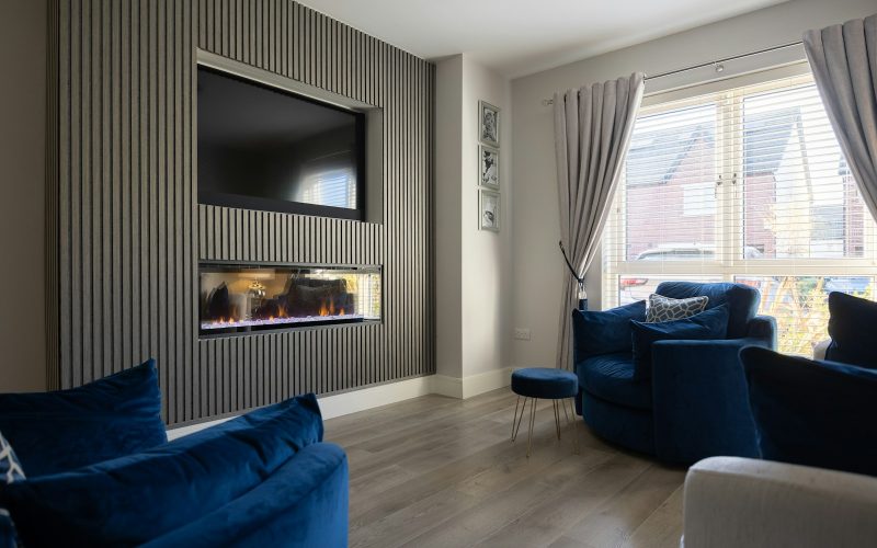a living room filled with furniture and a flat screen tv