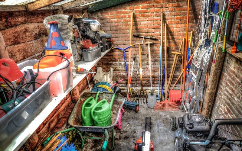Tuingereedschap netjes hangend opgeborgen in een schuur